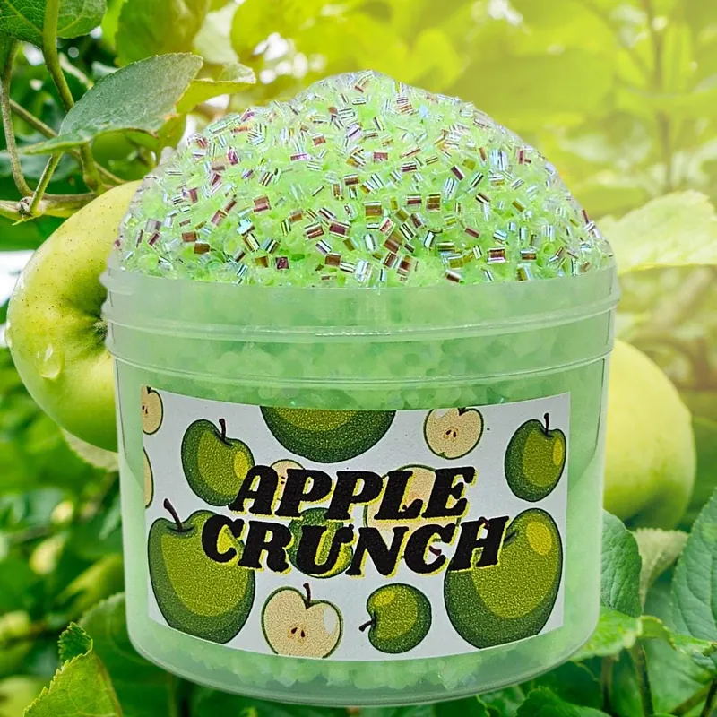 Apple Crunch jar of green crunchy slime in front of apples