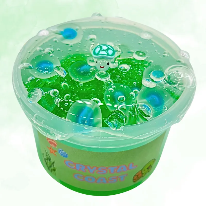 Crystal Coast jar of clear green slime with blue beads and a turtle charm