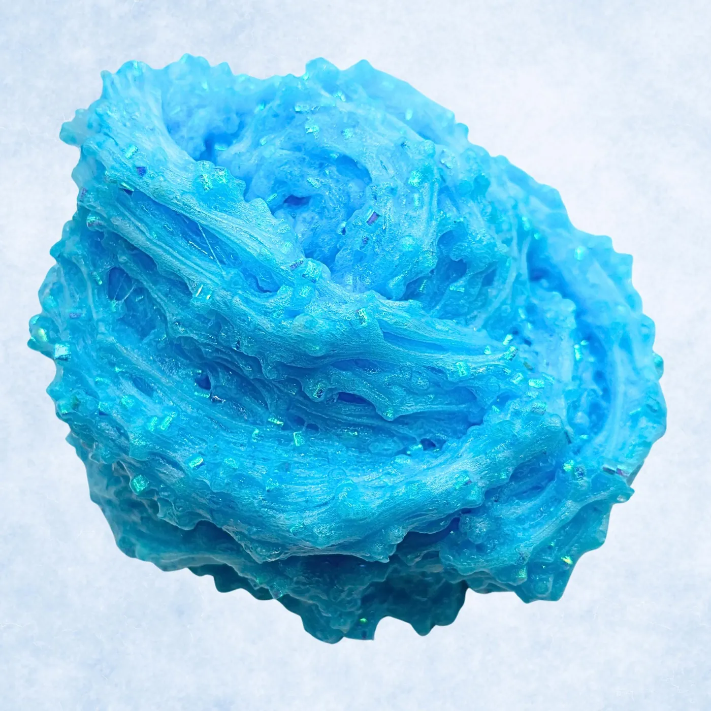 Close-up of blue bingsu bead slime with iridescent glitter