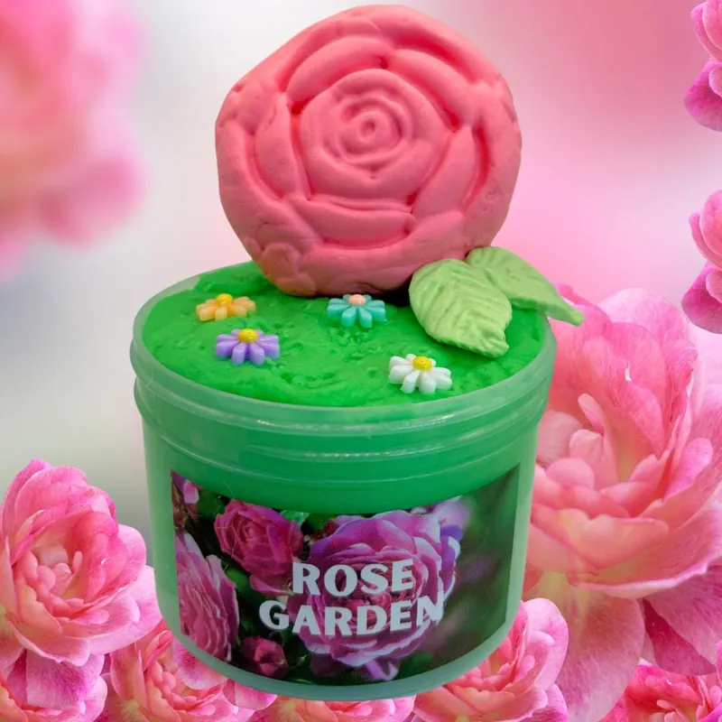 Rose Garden jar of green slime with a pink clay rose topper among roses